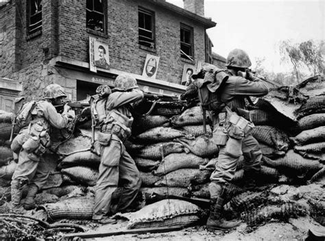 U S Marines Take Cover Behind Sandbags During An Engagement With Kpa