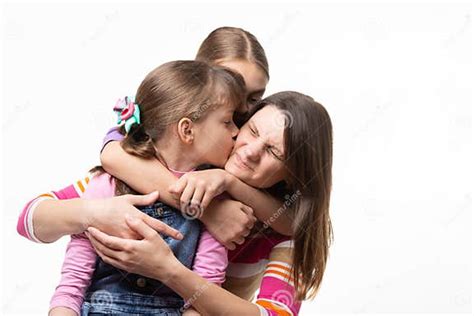 two daughters kiss mom isolated on white background stock image