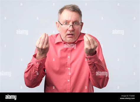 senior man  angry showing italian gesture stock photo alamy