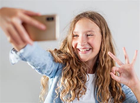 Smiling Teen Making Selfie Photo On Smartphone Over White Background