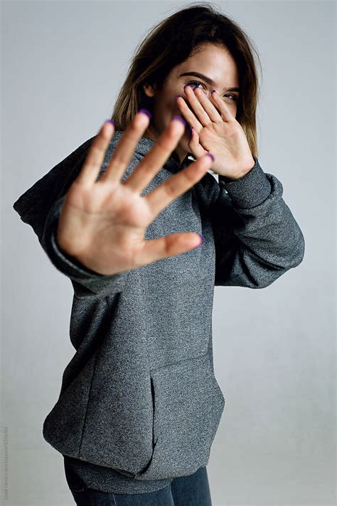 teen girl hiding face  palm hand  camera  stocksy contributor danil nevsky stocksy