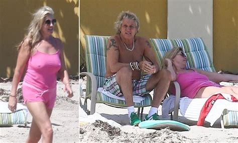 penny lancaster 49 strolls down the beach in a pink