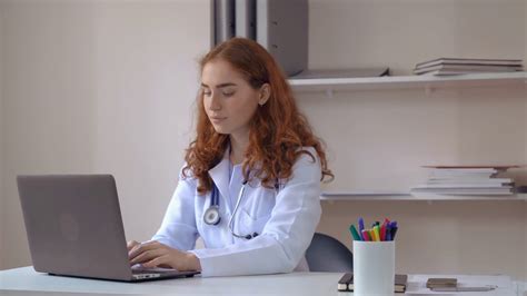 Redhead Doctor Using Computer In Hospital Stock Footage Sbv 315494902