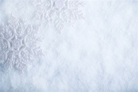 two beautiful sparkling vintage snowflakes on a white frost snow