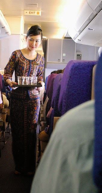 pretty singapore airline flight attendant doing in flight