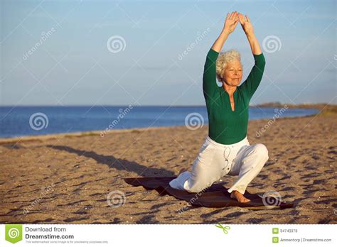 senior woman stretching on the beach stock image image