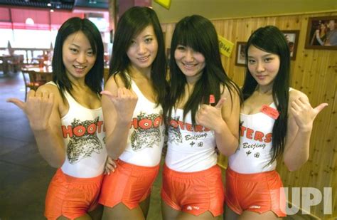 Chinese Hooters Waitresses Pose For A Photograph In Beijing