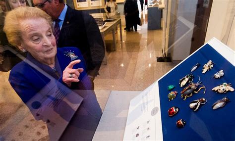 former secretary of state madeleine albright shows some of her bug pins that she wore during a