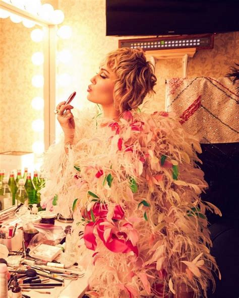 Miley Cyrus In An Outrageous Outfit Of Pink Feathers 5