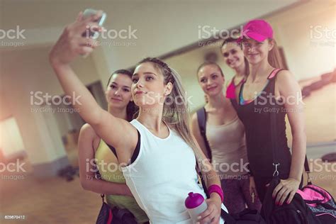 happy girlfriends group taking selfie in gym after exercise foto de