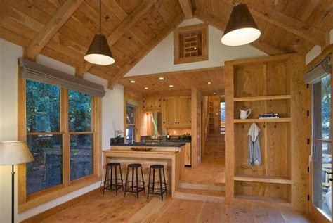 rustic guest cabin features extensive custom interior woodwork    bedroom