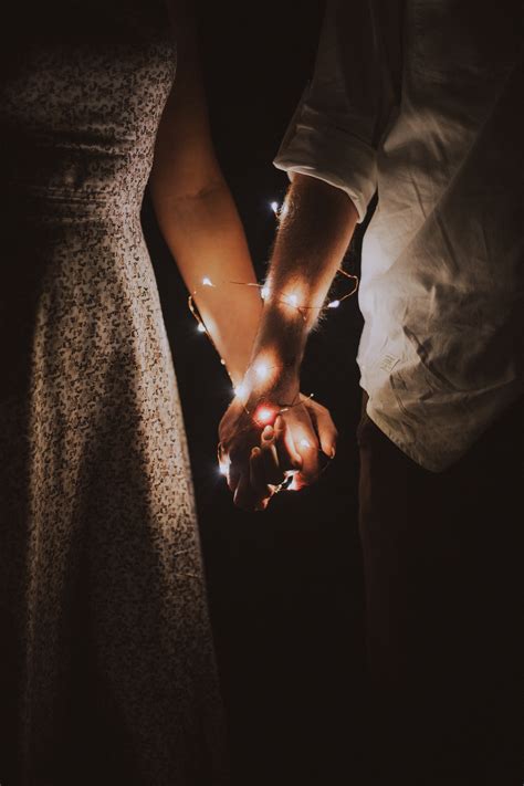 Man And Woman Holding Each Others Hand Wrapped With String