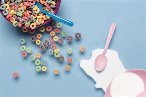 free photo bowl of cereals and splash of milk with pink spoon