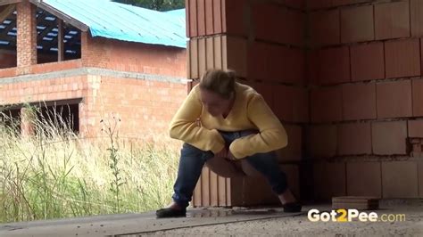 blonde teen pisses on a building site to relieve pee