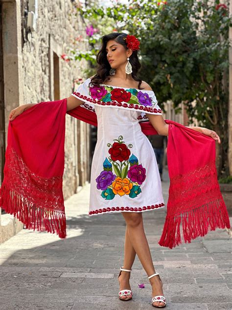 young beautiful woman wearing traditional mexican dress   city