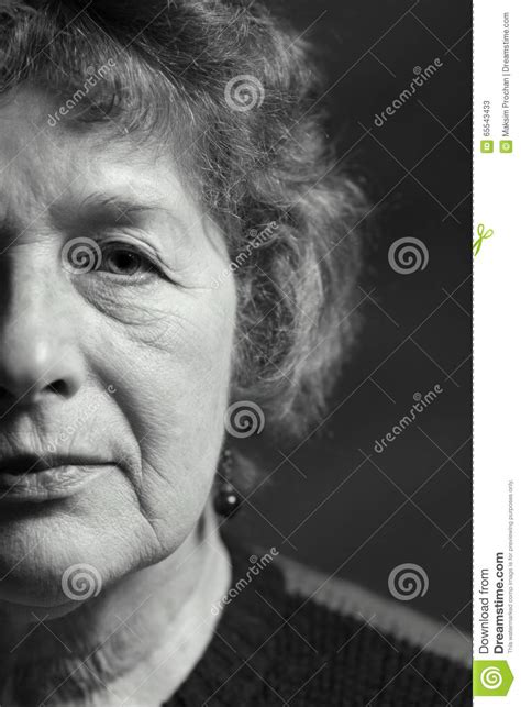 portrait of a beautiful older woman with glasses stock