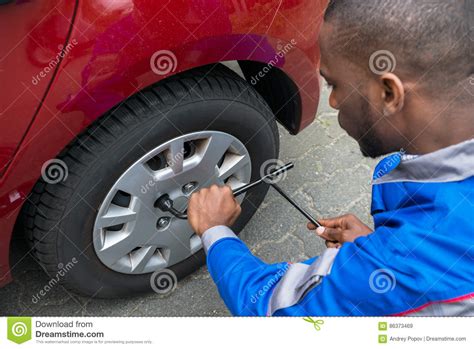 mechanic changing tire  wrench stock image image  male adult