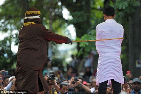 man and woman are caned 100 times each in brutal