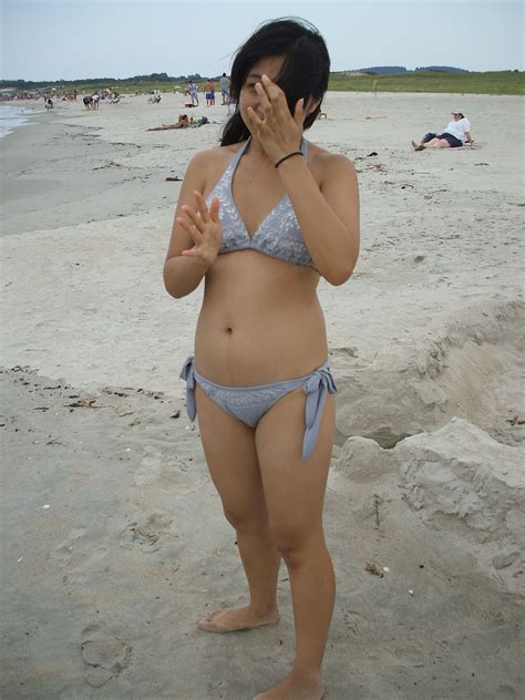 cute asian teen frolicking in grey bikini