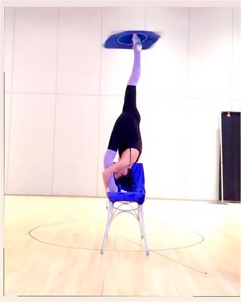 Girl Does A Split Between Chairs While Guy Shoots Apple Balanced On Her