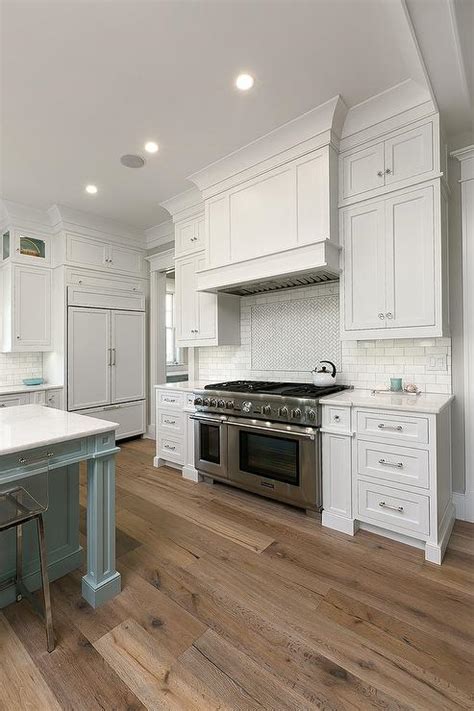 white kitchen cabinets  sawn oak wood floors transitional kitchen