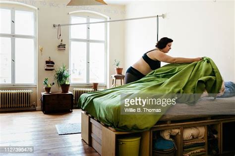 Curvy Woman Making Her Bed Photo Getty Images