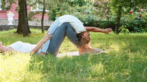 mother and her little cute daughter doing yoga exercise