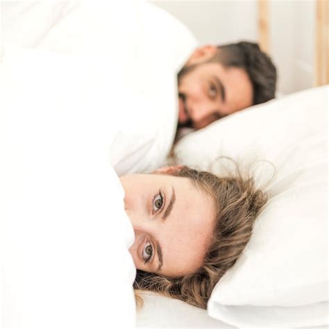 Free Photo Couple Covered In Blanket Lying On Bed