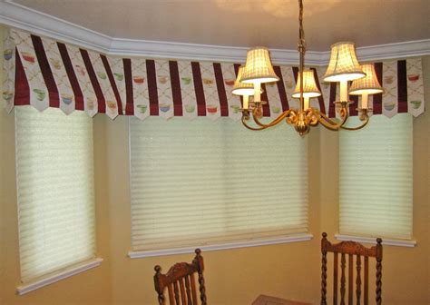 chandelier hangs   ceiling  front   windows  matching valances