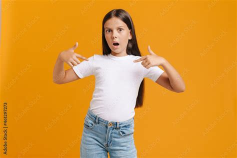 white brunette girl expressing surprise while pointing finger at