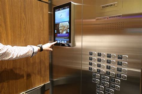 interactive digital screens in condo elevators installed at eye level