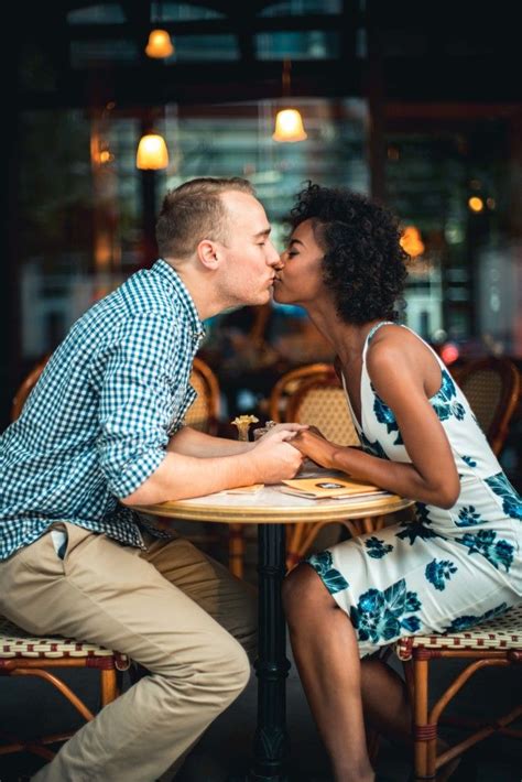 gorgeous interracial couple taking engagement photos at a cafe love