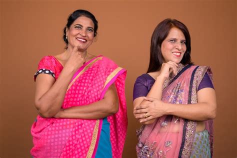 premium photo two mature indian women wearing sari indian traditional