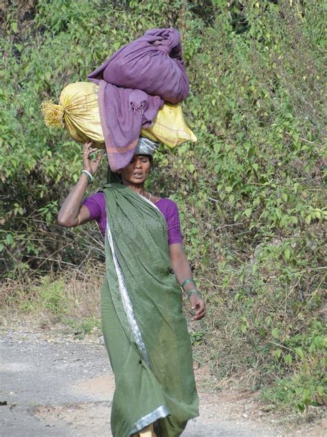 woman carries goods on her head editorial photo image of brown