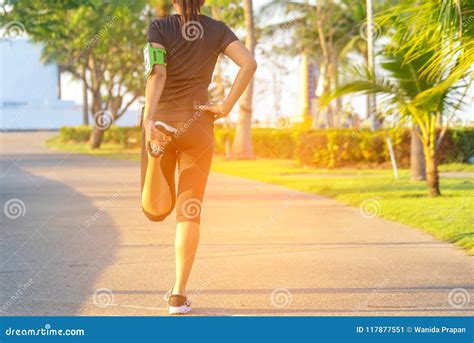 Healthy Life Asian Fitness Woman Runner Stretching Legs Before Run