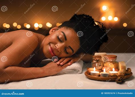 smiling african woman lying  massage table  spa stock photo image