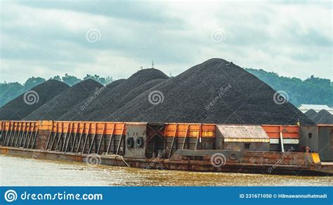 barge full  black coal cruising  mahakam river borneo indonesia stock photo image