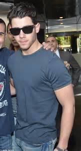 nick jonas flaunts his bulging biceps in tight t shirt as he poses for