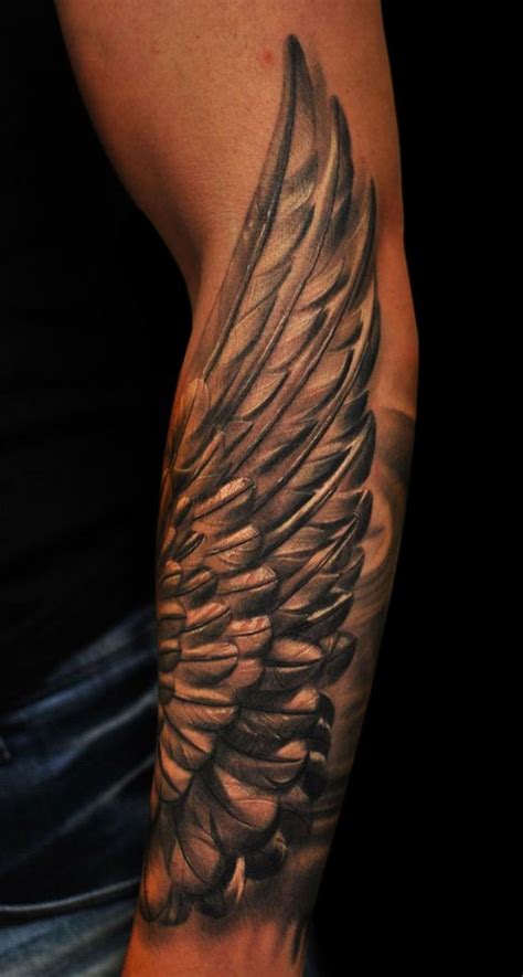 A Man S Arm With An Angel Wing Tattoo On It