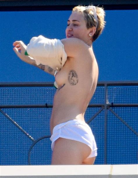 hot miley cyrus naked boobs while putting shirt on sexy
