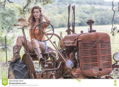 photo about brunette model with an old tractor image of fresh