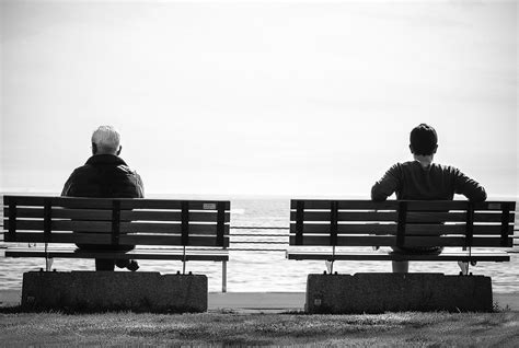 photo grayscale photo  person sitting   separate benches