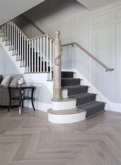understated elegance   hallway  medium wood herringbone flooring  grey tones