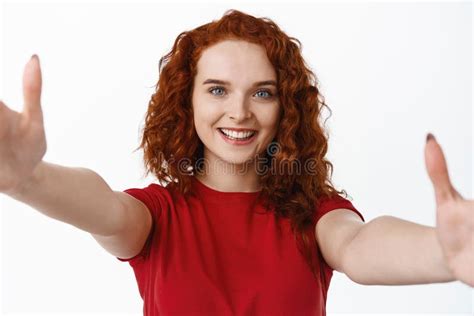 Portrait Of Redhead Woman In T Shirt Stretch Out Hands To Hug You Face