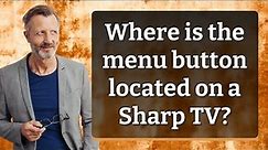 Where is the menu button located on a Sharp TV?