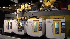 Two Overhead Robots Load Unload Four FANUC ROBODRILL Machine Tools FANUC Robotics