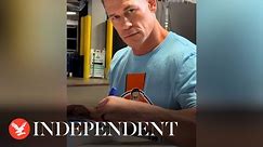 John Cena signs autographs without looking at page