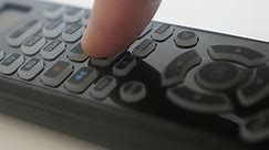 Pressing PAUSE button on TV remote control 4K footage