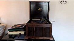 Underneath the mellow "1910 handcrank record player or gramophone/phonograph)
