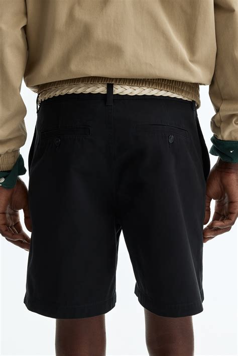 Relaxed Fit Chino shorts - Black - Men | H&M IN